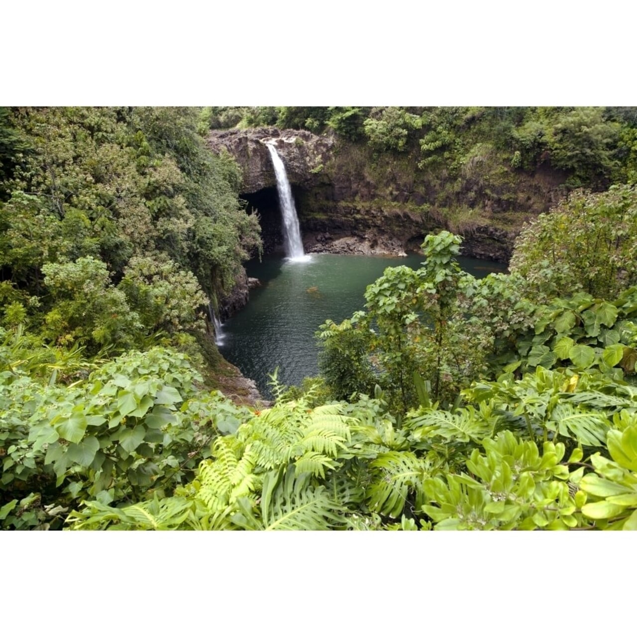 Posterazzi Hawaii Hilo Rainbow Falls surrounded by lush greenery. Poster Print